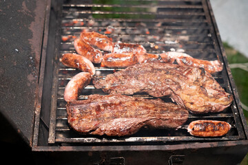 Chorizo and meat being grilled