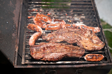 Chorizo and meat being grilled