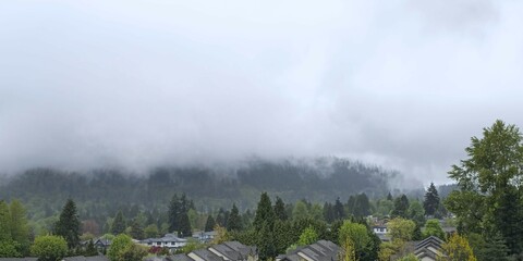Fog in the mountains. A town at the foot of the mountains
