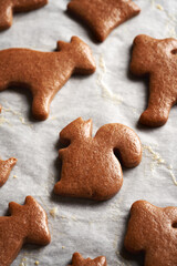 Baked homemade gingerbread Christmas cookies brushed with egg on a baking sheet