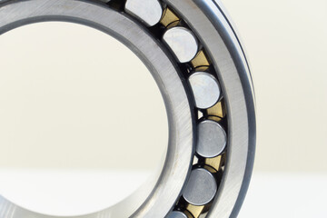 Metal ball bearing close up on a white background. Friction bearing. Shiny steel detail