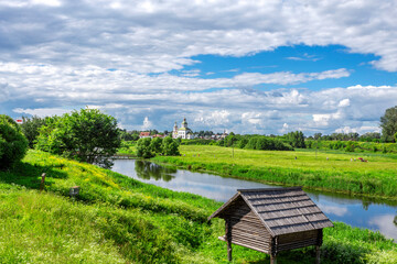SUZDAL, RUSSIA - Beautiful landscape of Suzdal overlooking the Kamenka River and the ancient Russian Church of Elijah the Prophet (Ilyinsky Church)At sunset