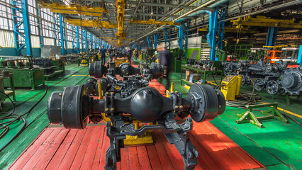 Fototapeta premium Conveyor assembly stage the body of tractor at big industrial factory timelapse