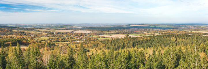 Obraz premium Karkonosze Mountains, Western Sudetes, vast landscape of the foothills, view from the observation tower on the top of Czerniawska Kopa mountain. Mountain landscape on a cloudy autumn day.