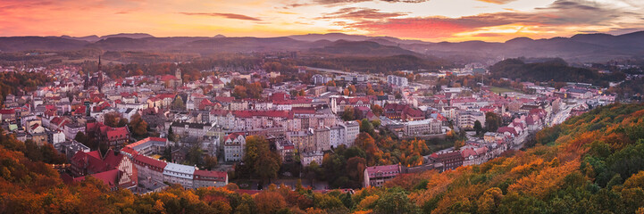 Walbrzych, sunset with a view of the city center and the Walbrzych Mountains. View of the city from the observation tower in Jan Sobieski Park, colorful autumn evening.