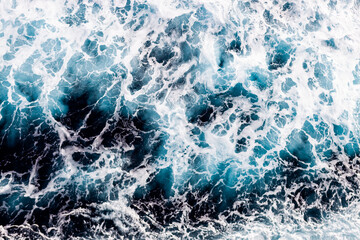 Sea water surface texture. Aerial view of elegant water with foam. Can be used in covers, packaging, posters, textures, brochures, art and design projects. Beautiful nature background image.