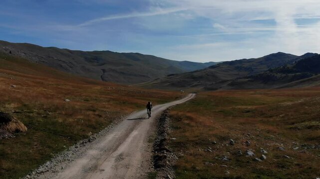 Drone flight over Mountainbiker in the mountains