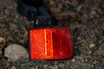 detached red bike reflector piece