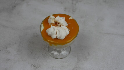 Tapioca pudding on coconut milk with chia seeds and meringue in a mango glaze