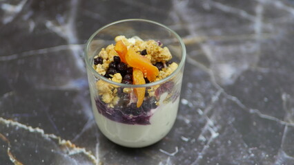 Yogurt with granola, forest fruits and dried apricots