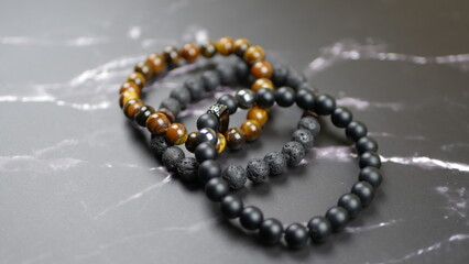 Men's bracelets on a black marble background
