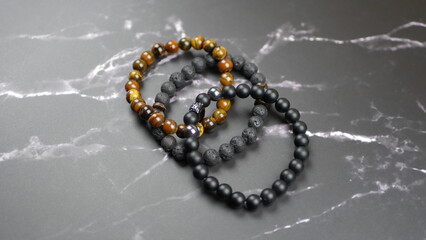 Men's bracelets on a black marble background
