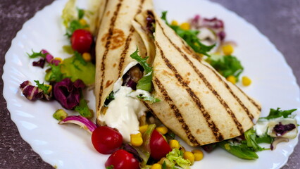 Tortilla wrap with vegetables and garlic sauce