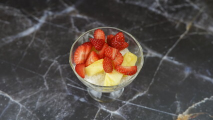 Dessert of tapioca balls with pineapple and mango in an ice cream cup