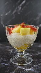 Dessert of tapioca balls with pineapple and mango in an ice cream cup