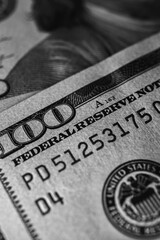 black and white photo, close-up view of a 100 dollar bill with details, texture. Perfect for finance, banking and wealth themes, vertical photos, wallpapers