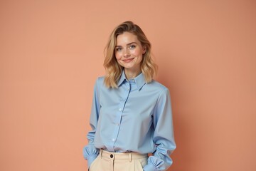 young woman with light skin and shoulder-length blonde hair, styled in loose waves. She is smiling warmly at the camera,