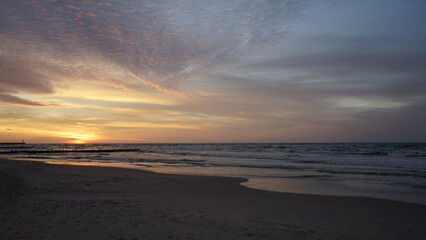 Obraz premium Sunset on the beach by the sea