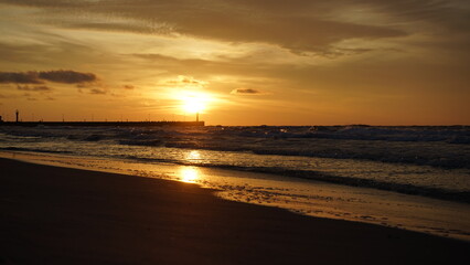 Obraz premium Sunset on the beach by the sea