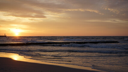 Fototapeta premium Sunset on the beach by the sea