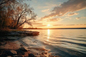 Scenic Sunset Over Lake with Golden Reflections on the Water, Silhouetted Trees, and Softly Colored Sky, Capturing Tranquil Beauty of Nature
