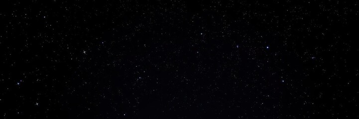 Fototapeta premium Dark night sky filled with twinkling stars and distant galaxies, black background, night scene