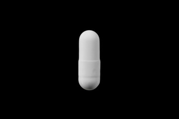 White Capsule on Black Background