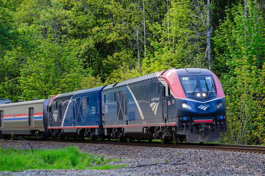 Index, WA, USA - May 1, 2024; Amtrak Empire builder Seattle to Chicago train in forested landscape