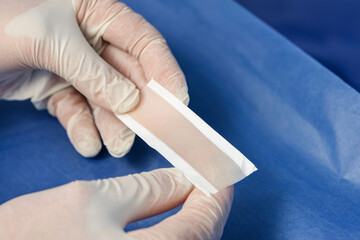 closeup of pig skin graft preparation, sterile blue background