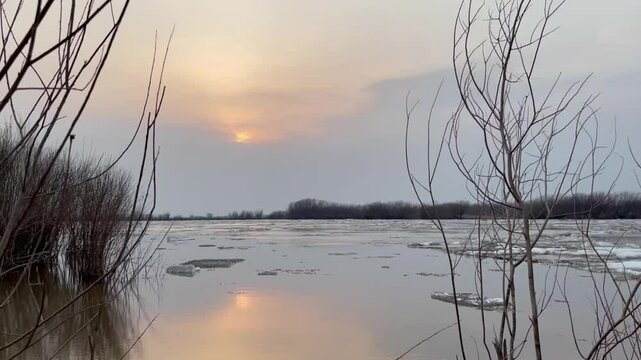 Ice drift on a river in spring during sunset