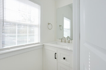 Bright Bathroom With White Vanity And Large Clean Mirror.