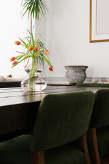 Dining Table With Tulips In Vase And Green Chairs