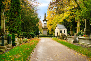 Autumn at the historic Melaten cemetery with a view of the central eagle column from the so-called...