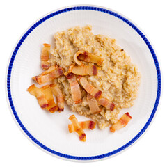 Delicious oatmeal porridge served with fried lard on platter. Isolated over white background