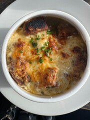 Top view of French onion soup garnished with parsley