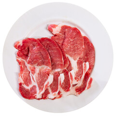 Fresh marbled pork loin head slices streaked with fat, prepared for cooking on plate. Isolated over white background