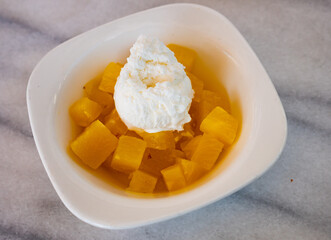 Juicy pineapple cubes with sweet ice cream served on plate