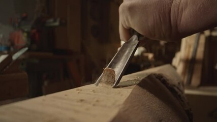 Extreme close-up view of a master carpenter man makes basting on the wooden board, craftsman work tool in the workshop