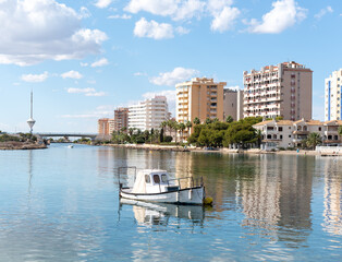 Buildings reflected in the Mediterranean Sea in the tourist destination of La Manga del Mar Menor, Murcia, Spain