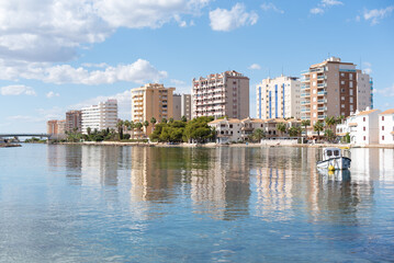 Buildings reflected in the Mediterranean Sea in the tourist destination of La Manga del Mar Menor, Murcia, Spain