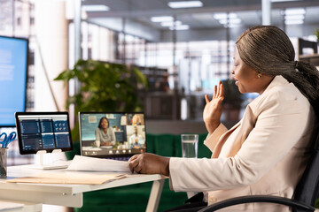 Business manager on videocall with stakeholders, greeting them, sharing profit growth plan. Professional in videoconference meeting with director board talking about startup evolution