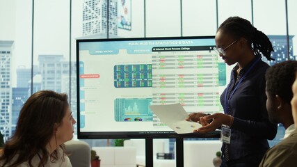 In a high end boardroom, employees gather to brainstorm ideas and create strategies, analyzing statistics to drive business development and ensure successful project. Enterprise solutions. Camera B.