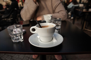 Espresso cup on a table in a typical French cafe, depicting coffee culture and dining atmosphere in France.