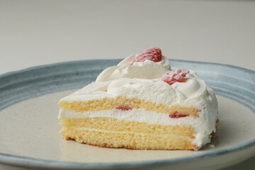 Two Japanese strawberry shortcakes on a stylish large plate on a white table