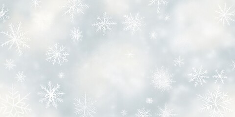 Snowflakes gently falling against a soft gray background, creating a serene winter atmosphere