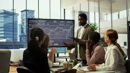The CEO and management team gathering in boardroom for a project briefing, focusing on enterprise solutions and aligning with the company strategic goals. Discussing budget plans. Camera B.