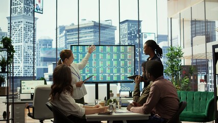 Management team holding a strategy session with the staff, focusing on digital marketing trends,...