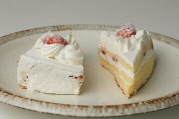 Two Japanese strawberry shortcakes on a stylish large plate on a white table