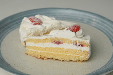 Two Japanese strawberry shortcakes on a stylish large plate on a white table