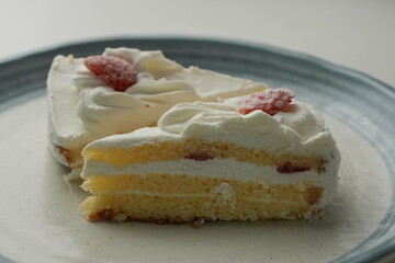 Two Japanese strawberry shortcakes on a stylish large plate on a white table